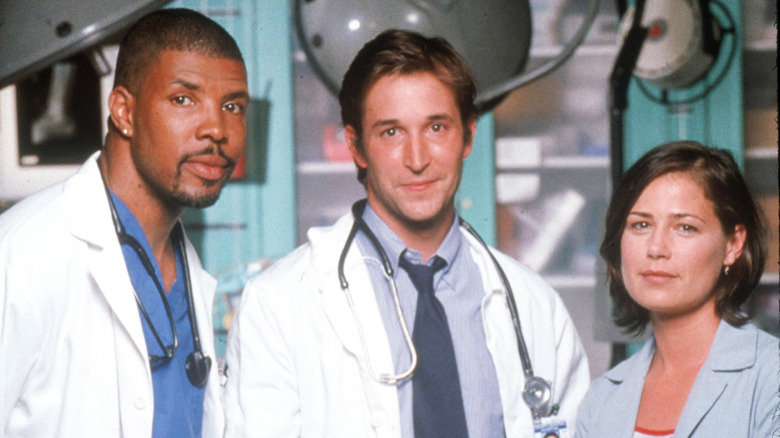 "ER" cast dressed as their characters and posing on set.