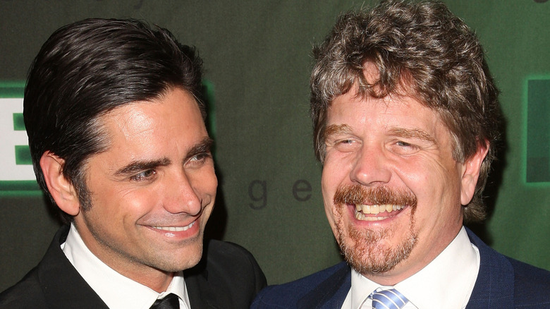 John Wells with John Stamos smiling together on ER red carpet.