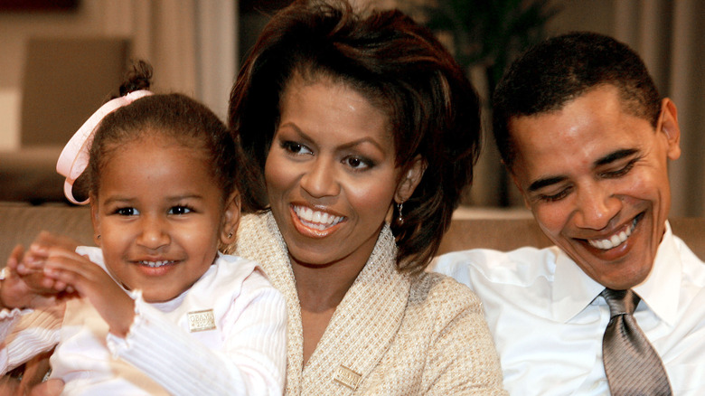 Michelle and Barack Obama sit with Sasha