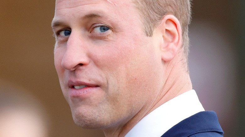 Prince William smiling over his shoulder