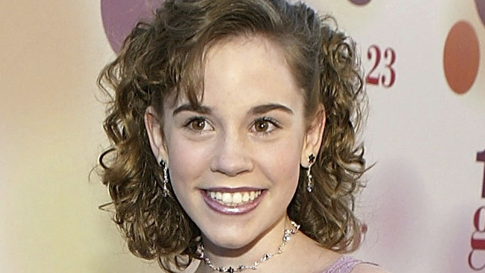 Christa Allen smiling at the 13 Going on 30 premiere