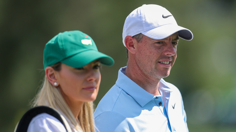 Rory McIlroy looking on with Erica Stoll during the Par Three Contest