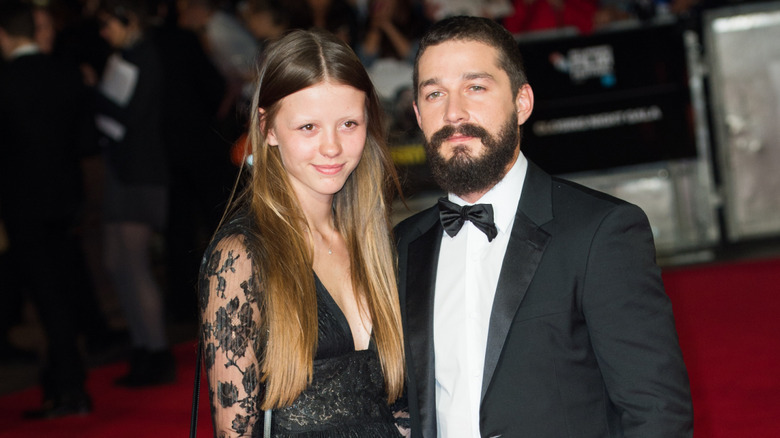 Mia Goth and Shia LaBeouf posing on red carpet
