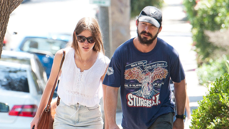 Mia Goth and Shia LaBeouf walking outside together