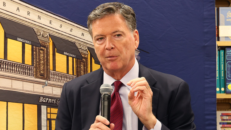 James Comey holding a microphone