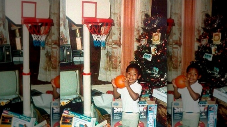 Young LeBron James poses with a basketball
