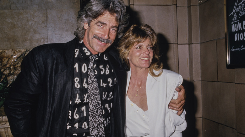 Sam Elliott and Katharine Ross posing for cameras in 1983