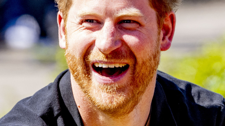 Prince Harry laughing outside