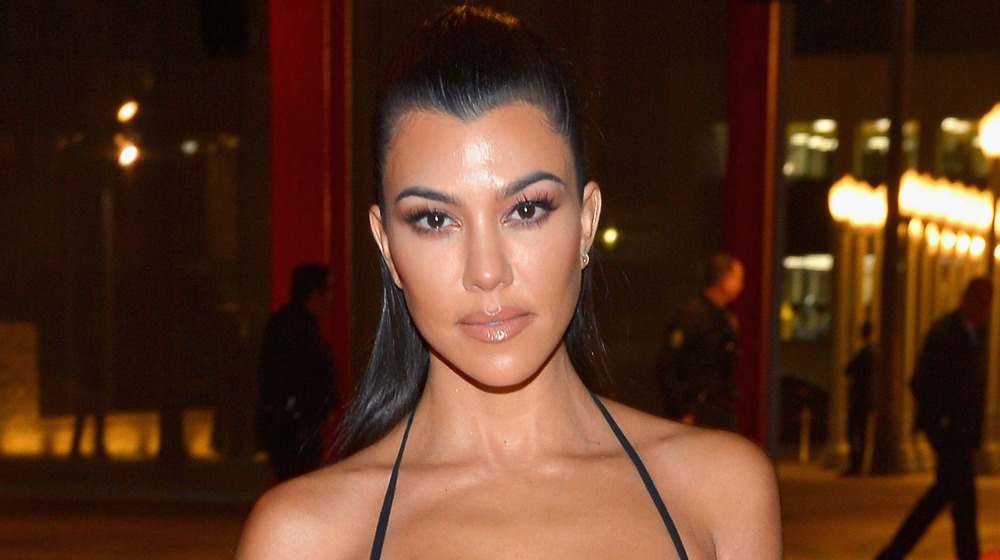 Kourtney Kardashian with a neutral expression