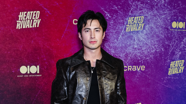 Hudson Williams at a premiere event for Heated Rivalry wearing a black leather jacket
