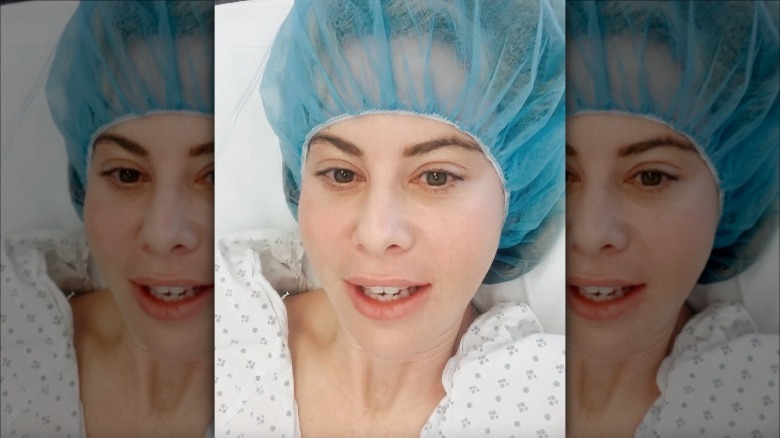 Tara Lipinski wears a hairnet and gown