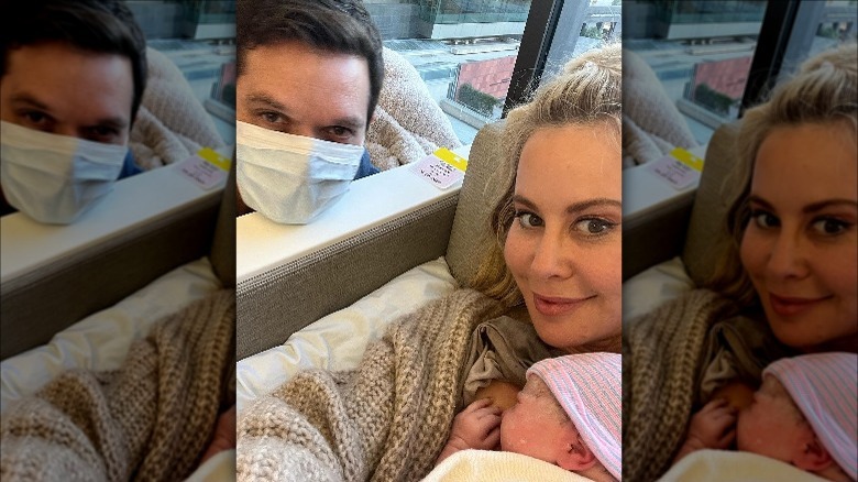 Tara Lipinski holds the baby next to Todd Kapostasy