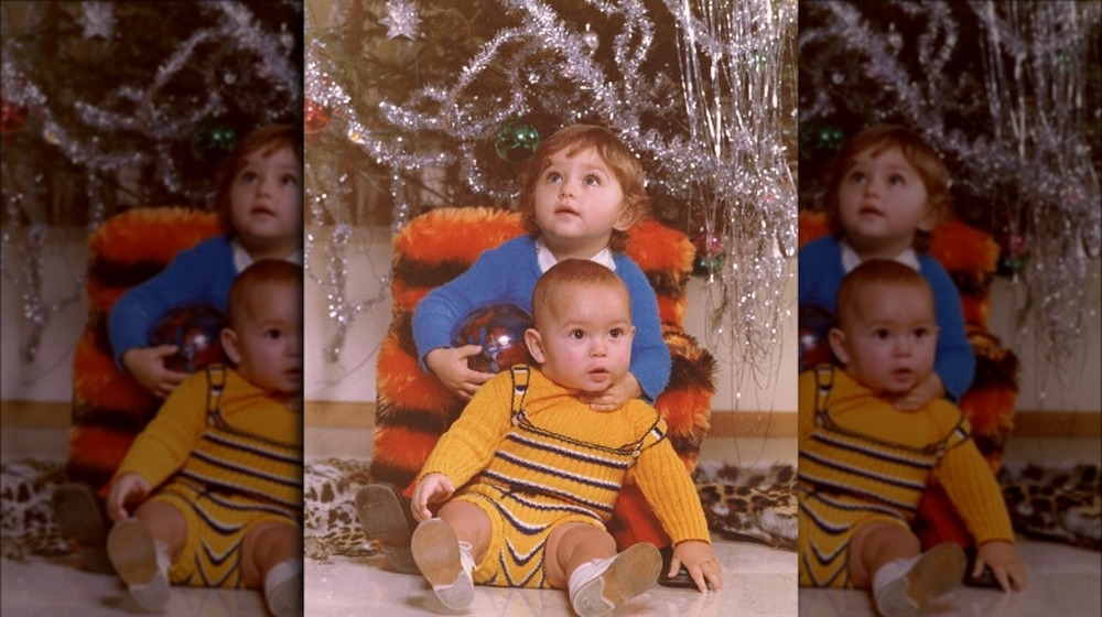 Giada De Laurentiis and Dino De Laurentiis posing together in front of the Christmas tree as children