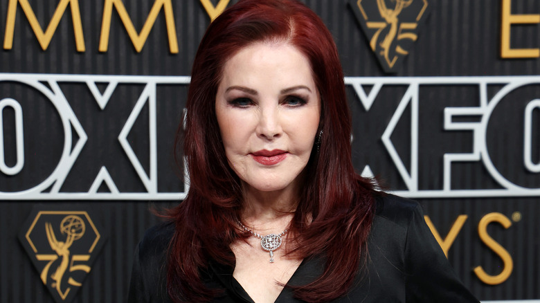 Priscilla Presley smiling in close up on red carpet