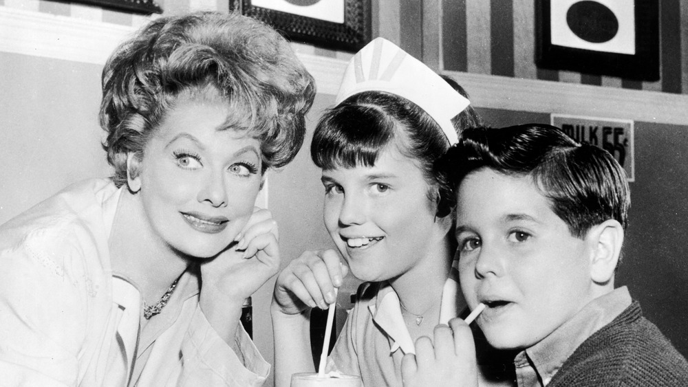 Lucille Ball, Lucie Arnaz, and Desi Arnaz Jr. drinking milkshakes