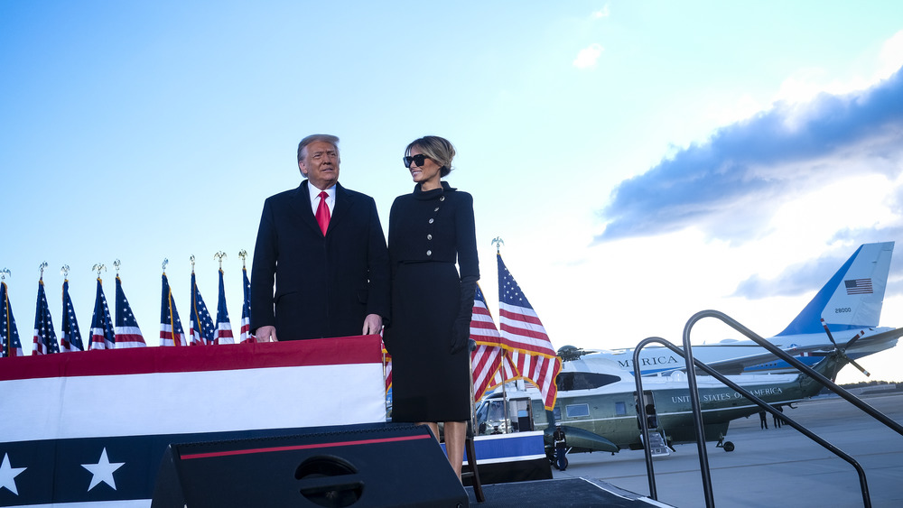 Melania and Donald Trump on a platform