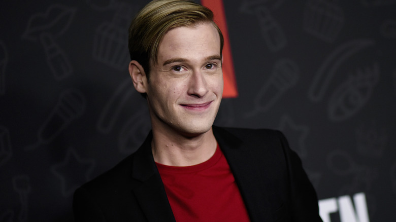 Tyler Henry smirking looking up