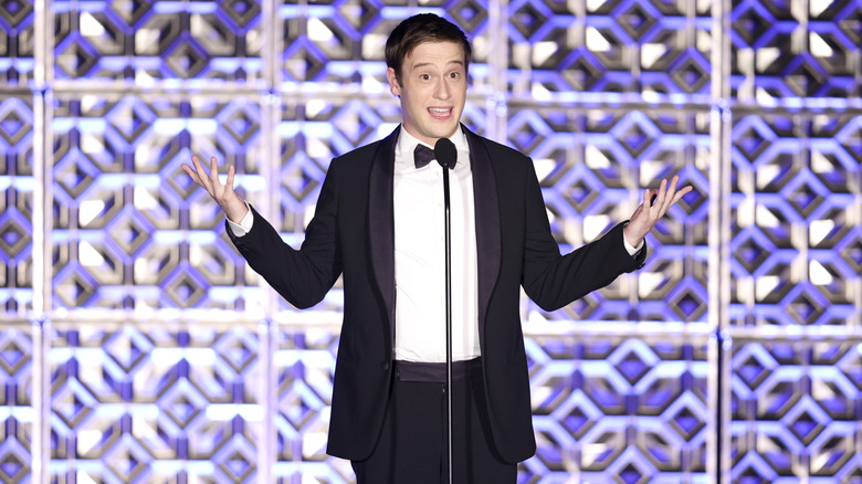 Tyler Henry tuxedo raising arms