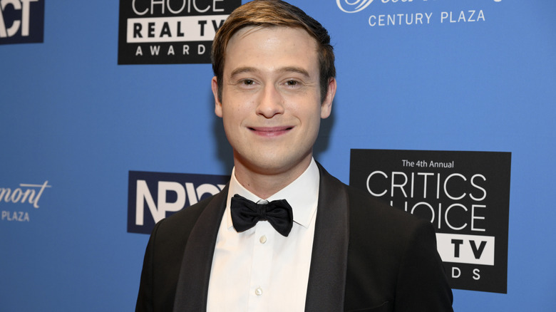 Tyler Henry in tuxedo smirking