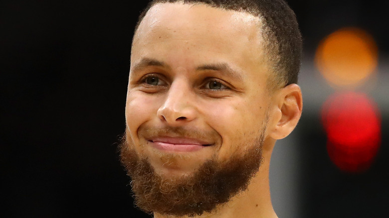 Stephen Curry smiling on court