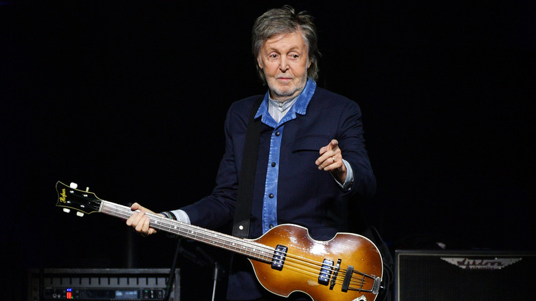 Paul McCartney performing on stage.
