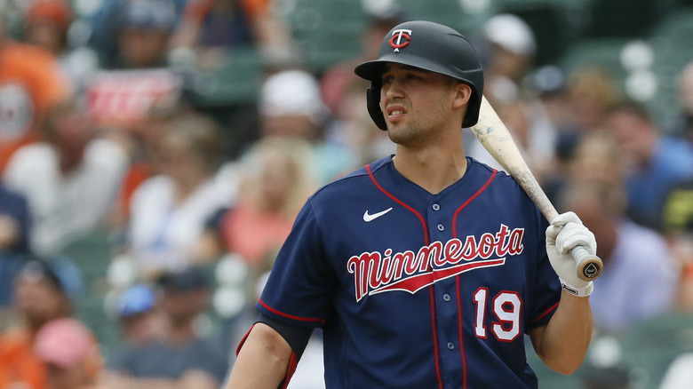 Alex Kirilloff holding a bat on the field