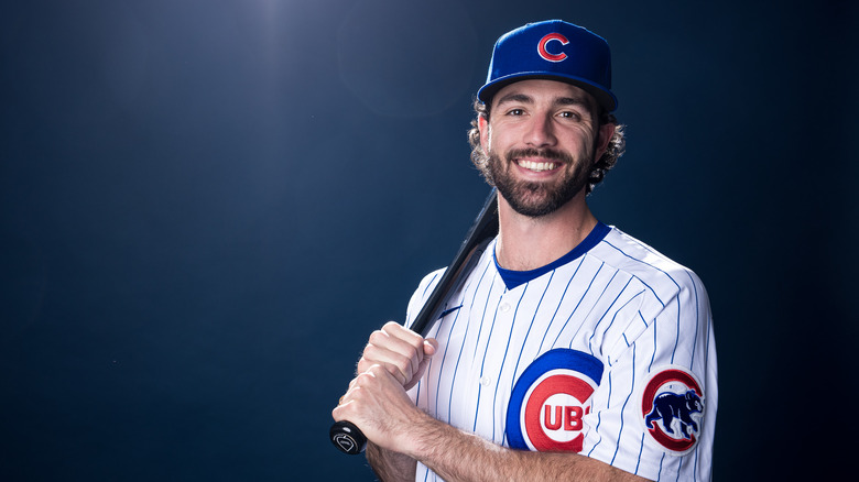 Dansby Swanson posing in uniform with a bat