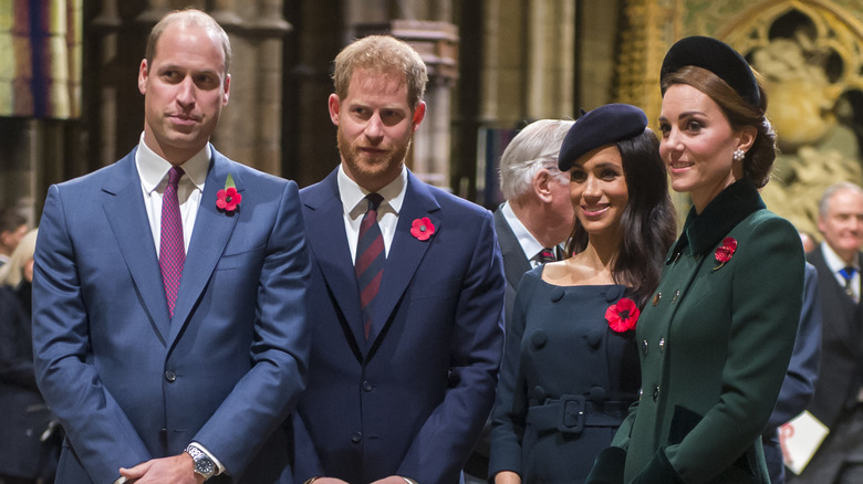 Prince William, Prince Harry, Meghan Markle, and Kate Middleton wearing red poppies