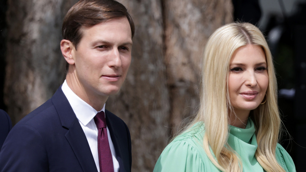 Jared Kushner and Ivanka Trump posing for the camera