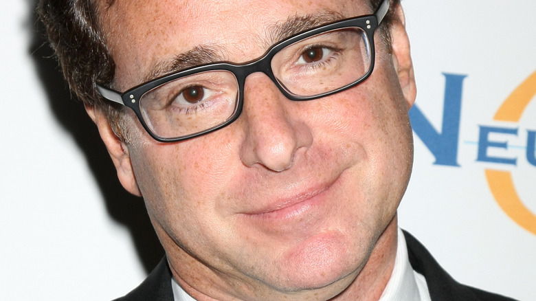 Bob Saget poses in black-frame glasses