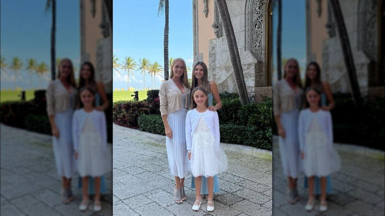 Vanessa, Kai and Chloe Trump pose together at a wedding.