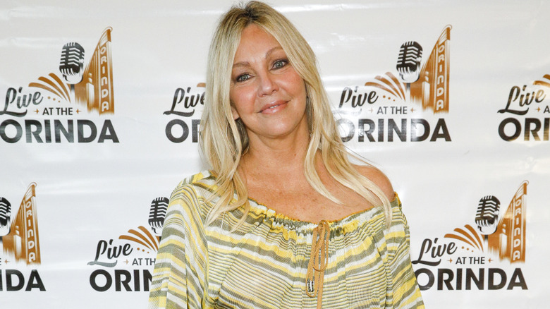 Heather Locklear wearing an off the shoulder summer dress at a red carpet event