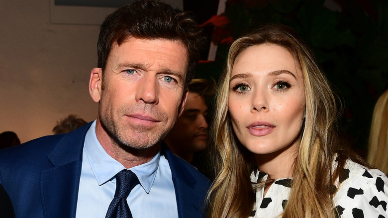 Taylor Sheridan and Elizabeth Olsen at Wind River cocktail party