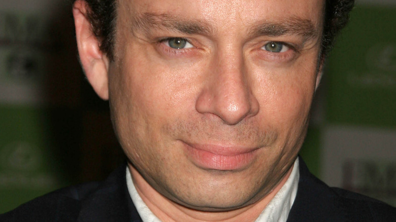 Chris Kattan smirks