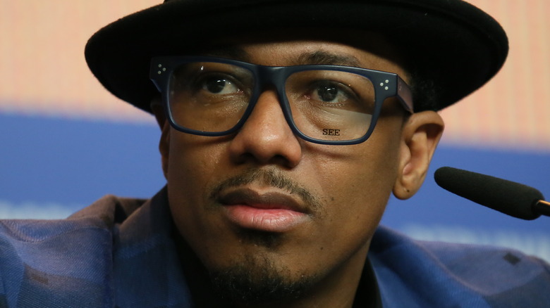 Nick Cannon in a hat and glasses