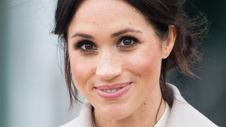 Meghan Markle smiles at an outing