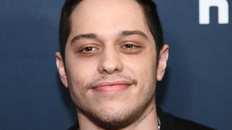 Pete Davidson smiles slightly