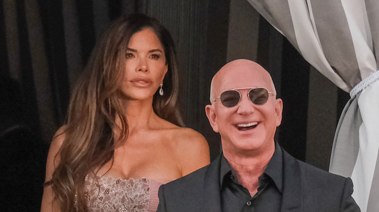 Lauren Sánchez Bezos walks behind Jeff Bezos while leaving hotel in Venice
