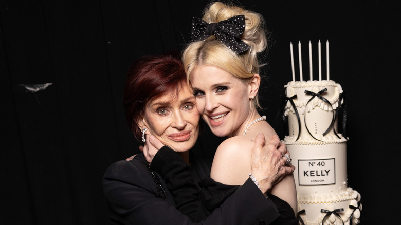 Sharon and Kelly Osbourne posing together at Kelly's 40th birthday party.