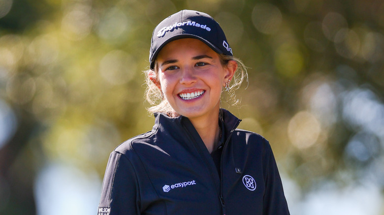 Kai Trump smiling big in her golfing outfit during a tournament
