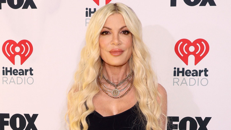 Tori Spelling pose in 2024