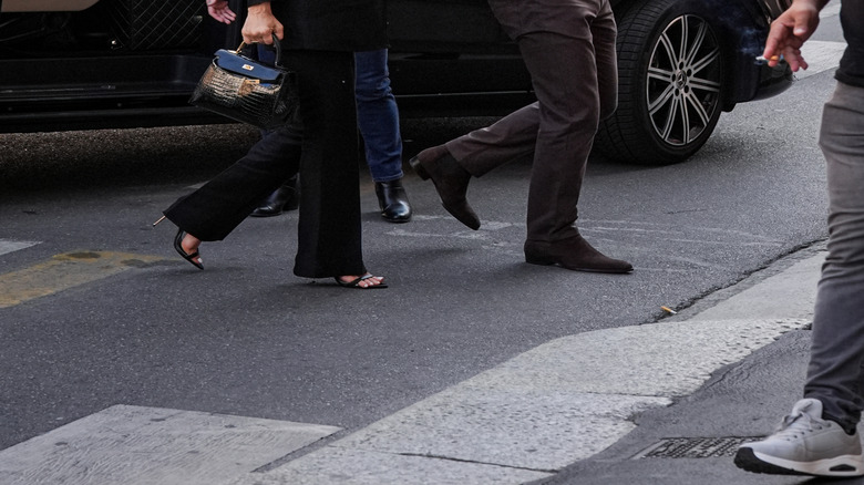 Lauren Sanchez Bezos and Jeff Bezos walking hand-in-hand.