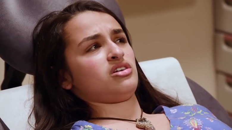 Jazz Jennings displaying a trouble expression while lying in an hospital bed.
