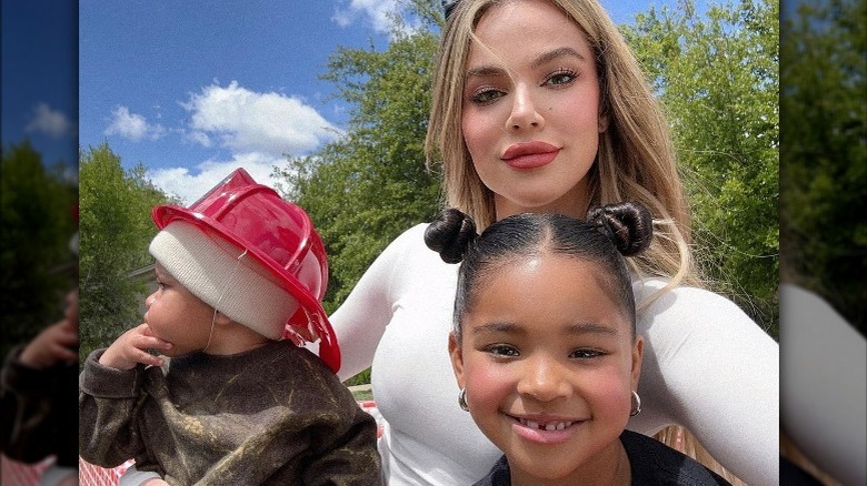 Khloe Kardashian posing with kids