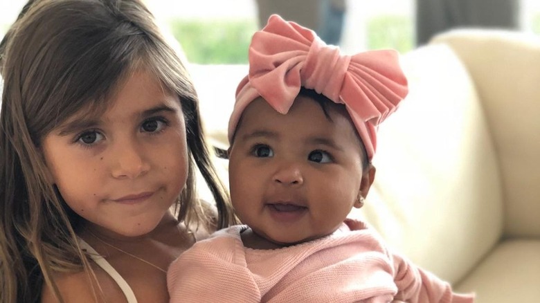 Penelope Disick posing with True Thompson