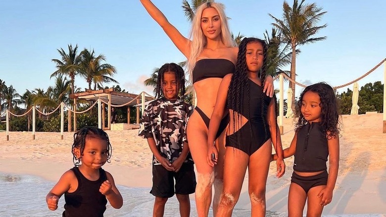 Kim Kardashian posing on beach with her kids