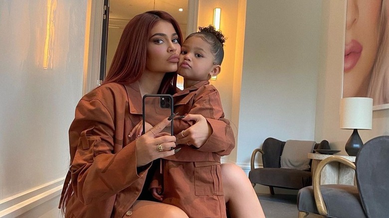 Kylie Jenner taking mirror selfie with Stormi
