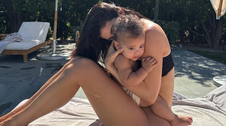 Kourtney Kardashian holding Aire