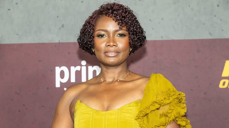 Sarah Niles wearing a yellow off the shoulder textured gown