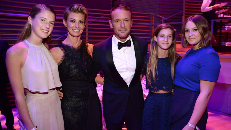 Tim McGraw, Faith Hill, Gracie McGraw, Audrey McGraw, and Gracie McGraw posing at a formal event